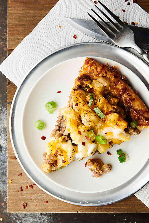 Overhead of slice of maple sausage breakfast pizza on a plate