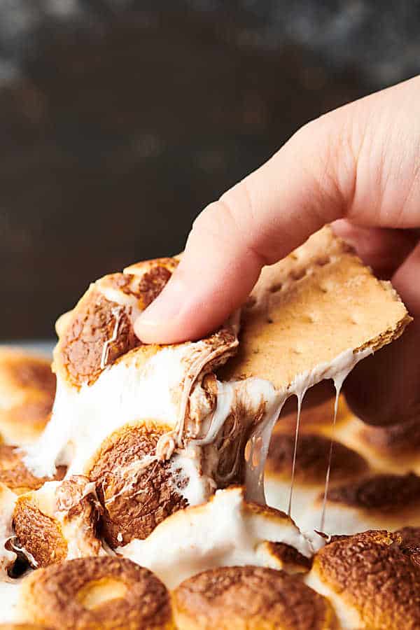 graham cracker dipping into smores dip