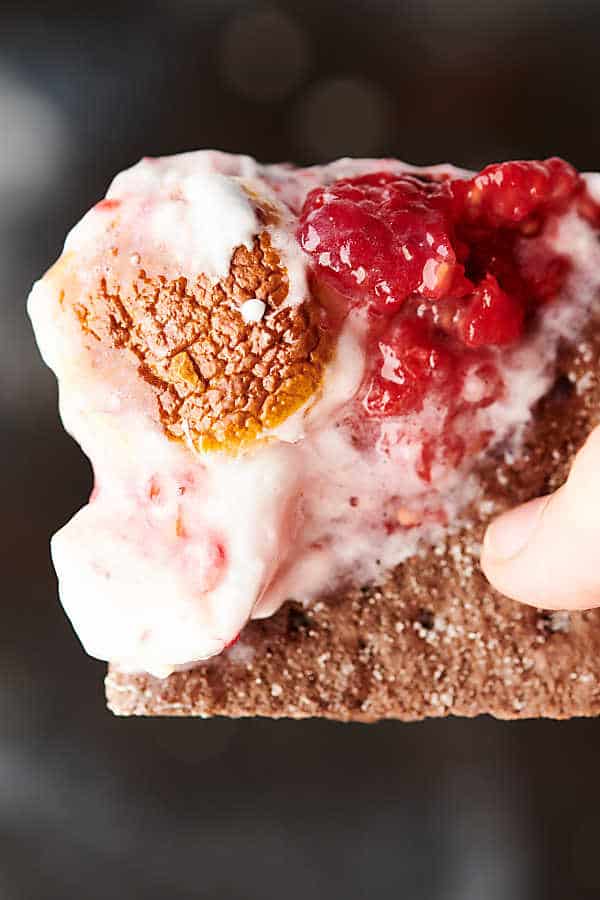 white chocolate raspberry smores dip on chocolate graham cracker