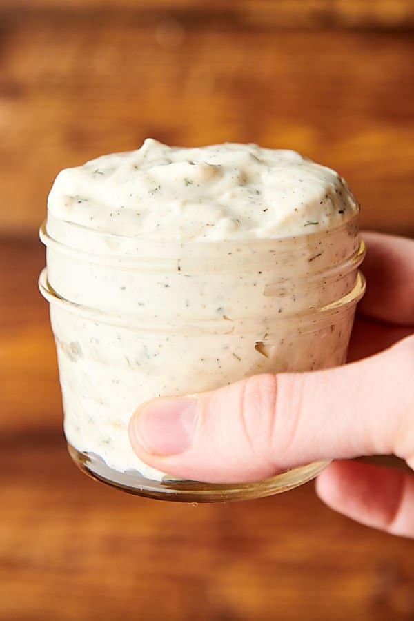 Jar of tartar sauce held