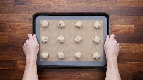 Cookie dough balls on baking sheet