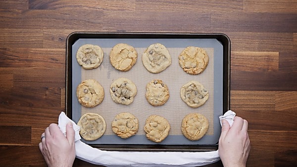 Baked chocolate chip cookies on baking sheet