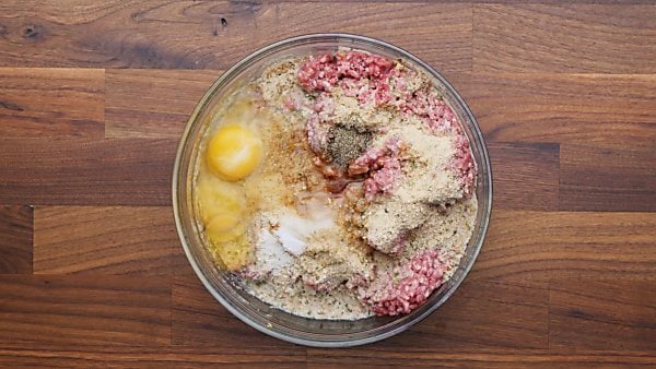 All meatloaf ingredients in mixing bowl