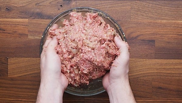 Meatloaf being mixed with hands