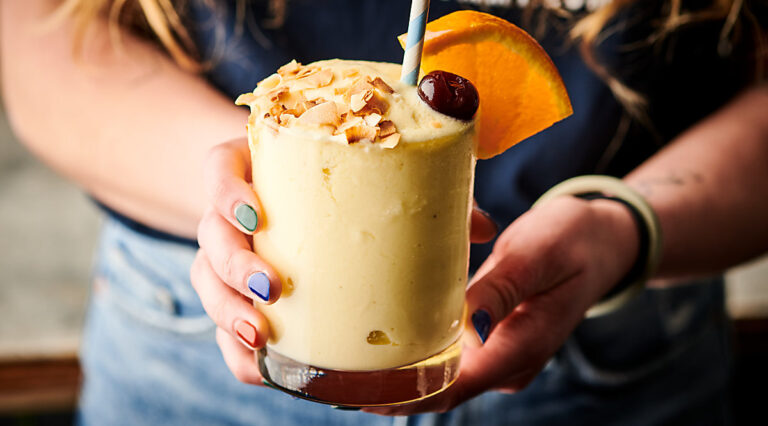 Cup of tropical smoothie held