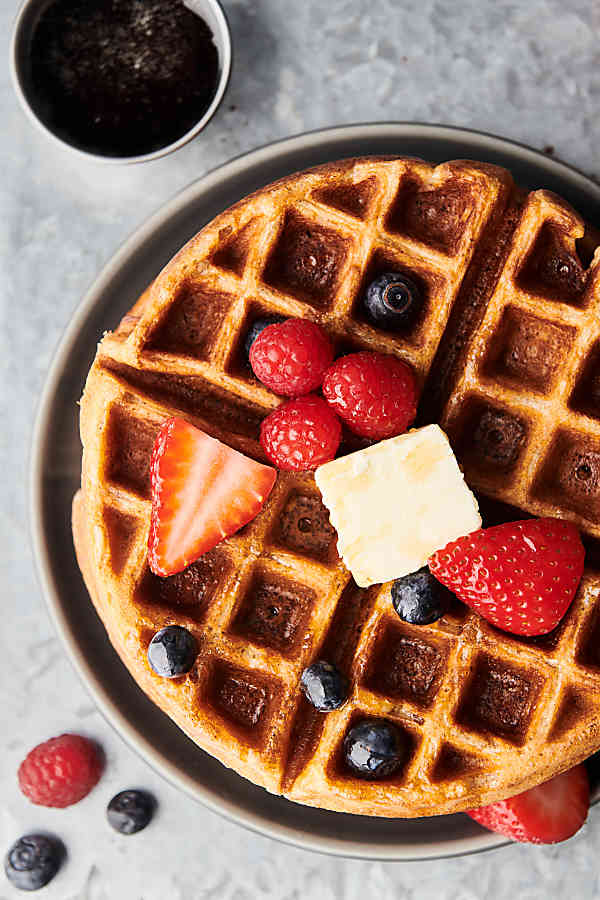 Waffle with butter and mixed berries above