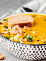bowl of butternut squash soup with slice of bread on top