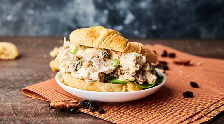 Chicken salad on a croissant on a plate