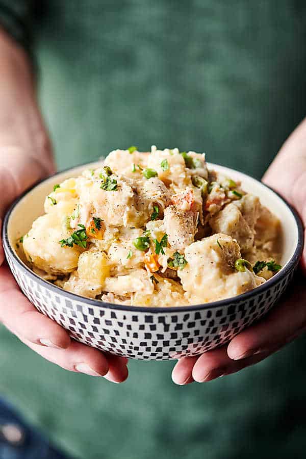 bowl of chicken and dumplings held