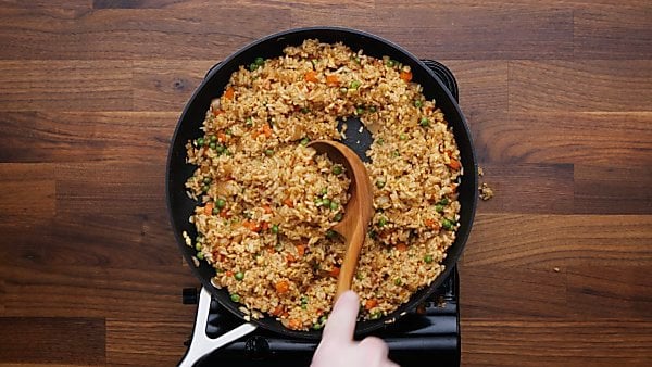 finished fried rice being scooped with ladle