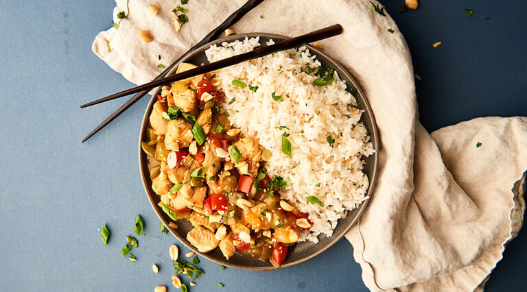 Kung pao chicken with rice on plate above