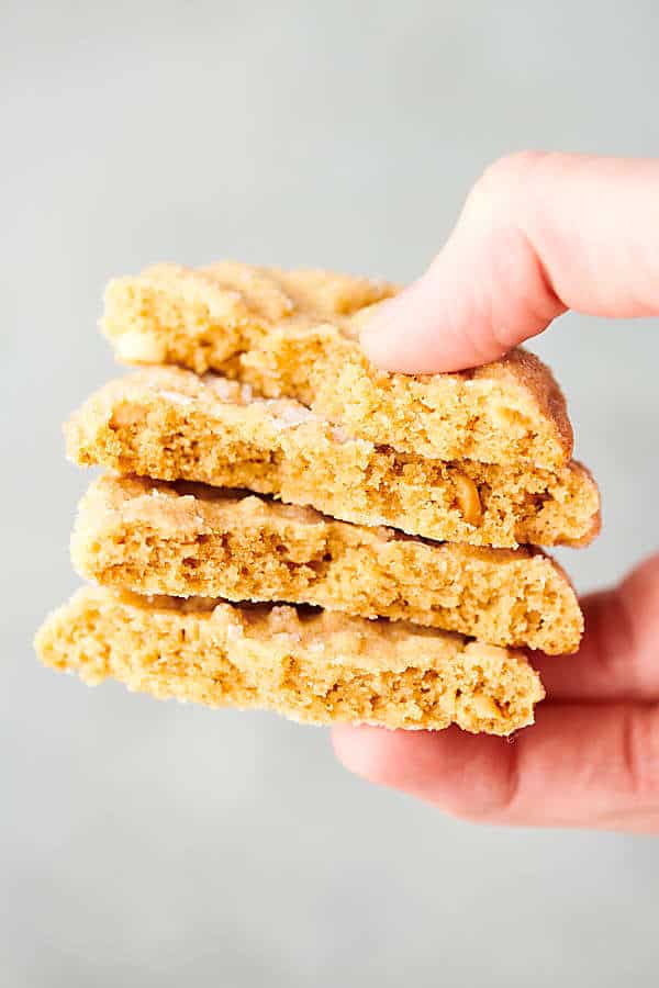 four halves of peanut butter cookies stacked and held