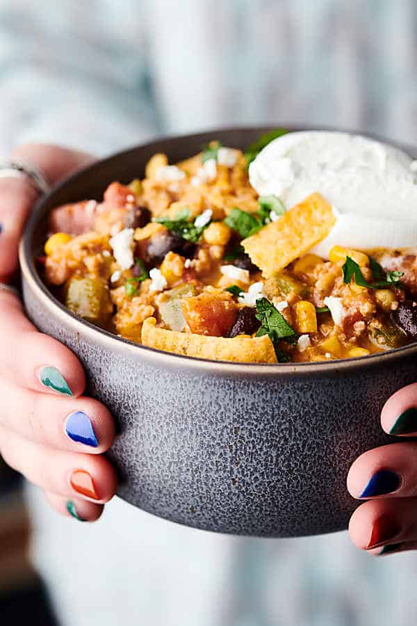 Bowl of taco soup held