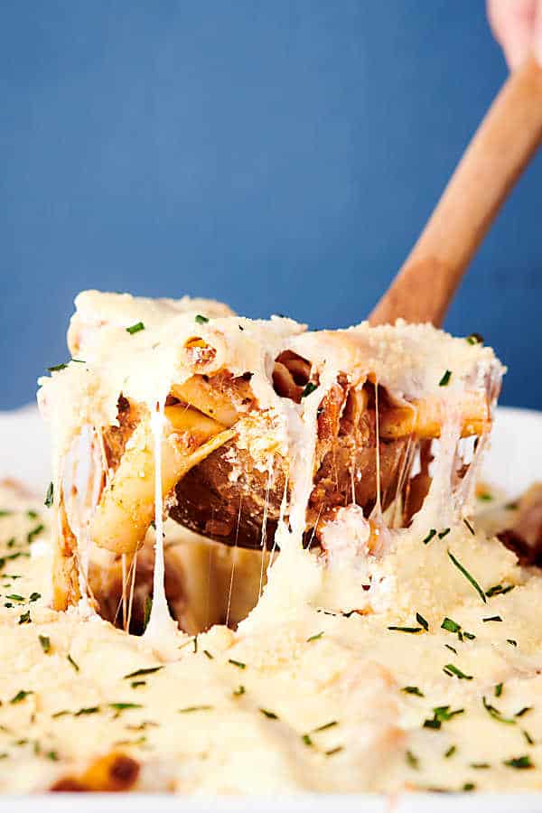 baked ziti being scooped with ladle