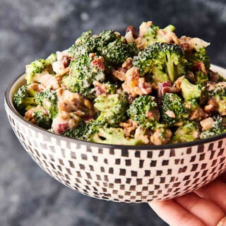 bowl of broccoli salad held