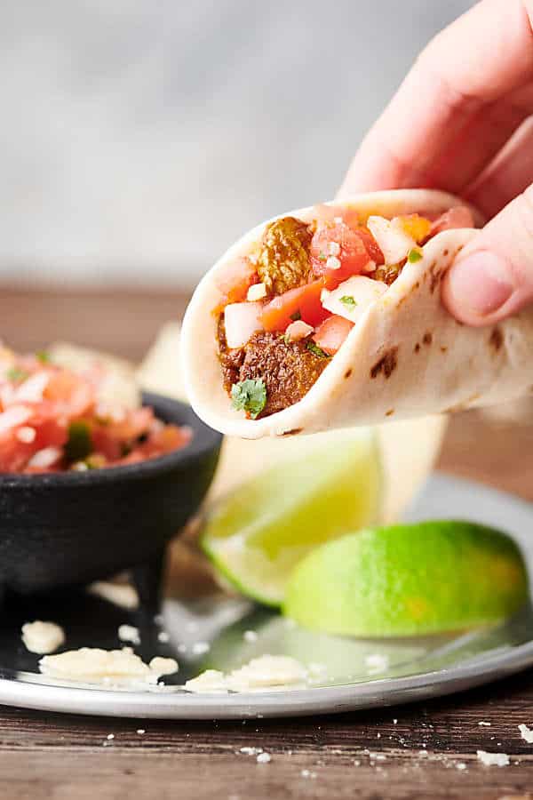 chicken taco being lifted off plate