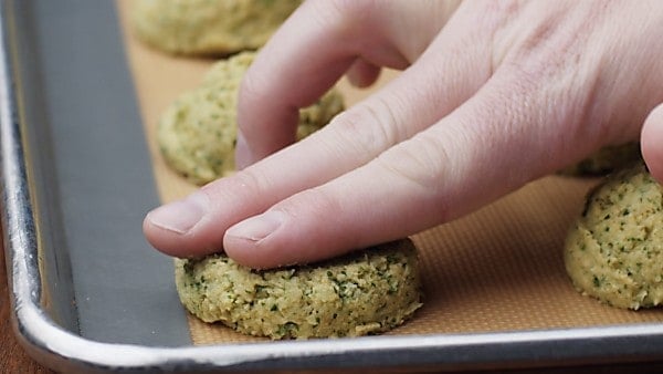 falafel being flattened with two fingers