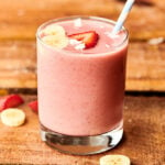 strawberry banana smoothie in cup with straw