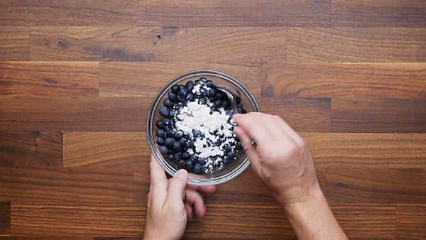 blueberries being tossed with flour