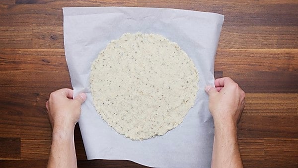 pizza dough pressed on pizza pan