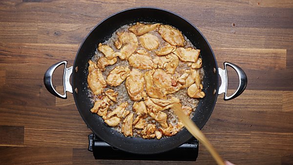 chicken being cooked in skillet