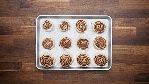 unbaked dough rolls on baking sheet