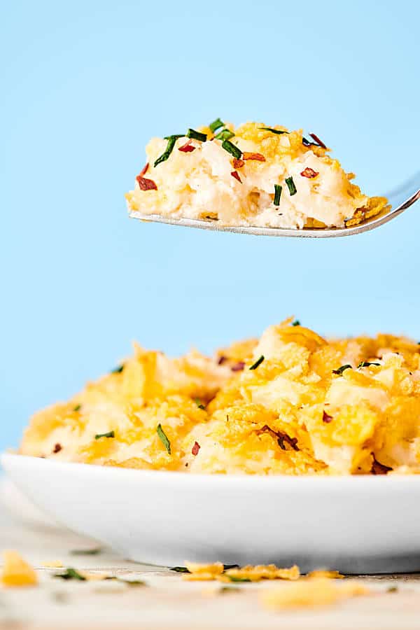 plate of hashbrown casserole, bite on fork held above