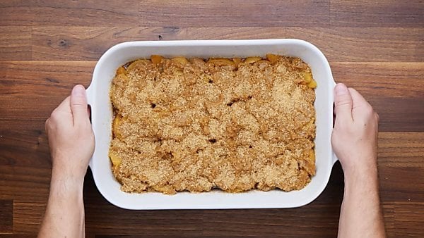 unbaked peach cobbler in baking dish