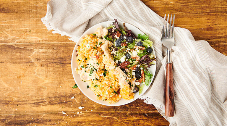 chicken casserole on plate with salad above