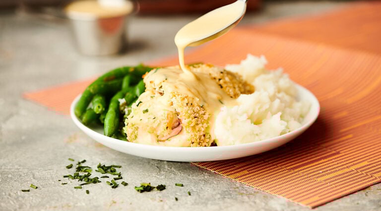chicken cordon bleu on plate with rice and green beans