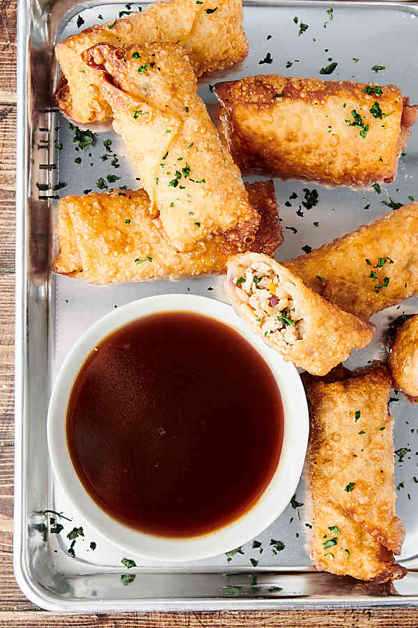 egg rolls on tray with soy sauce above