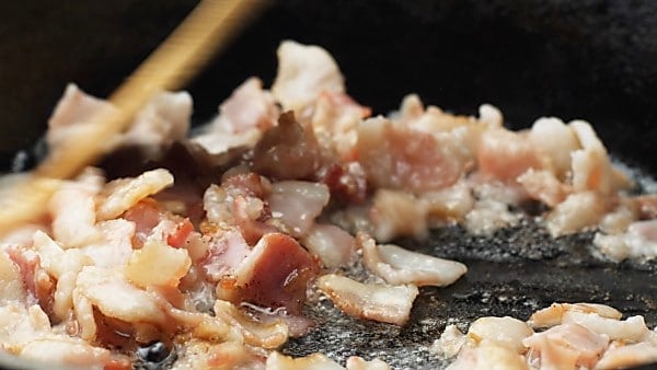 bacon being cooked in skillet