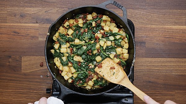 spinach and bacon added to onion/potatoes