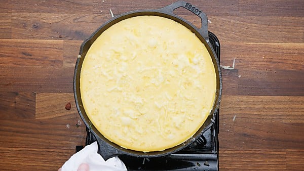 egg mixture poured over veggies in skillet