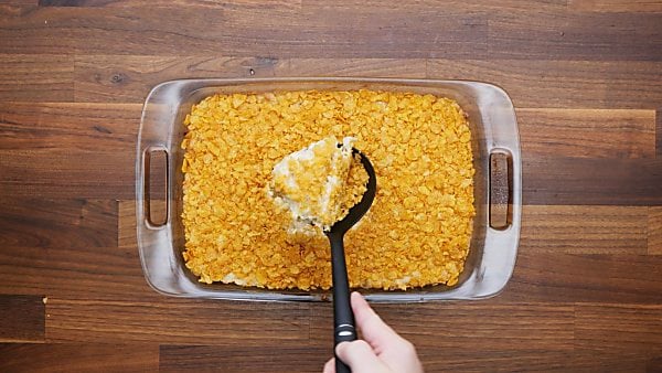 finished hashbrown casserole being scooped with ladle