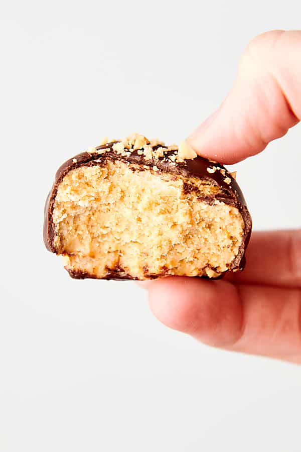 peanut butter ball with bite out held