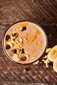 glass of peanut butter banana smoothie above
