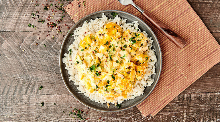 chicken divan over rice on plate above