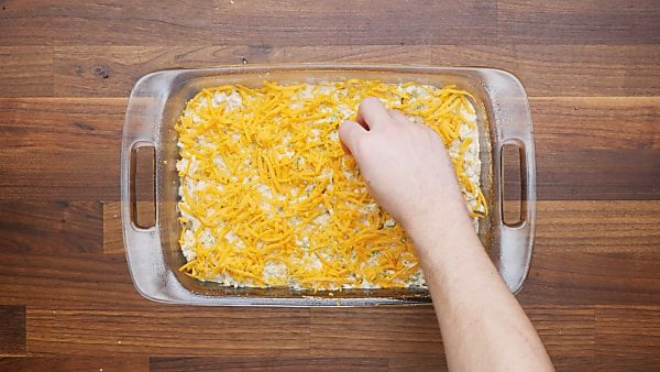 chicken mixture in baking dish topped with cheese