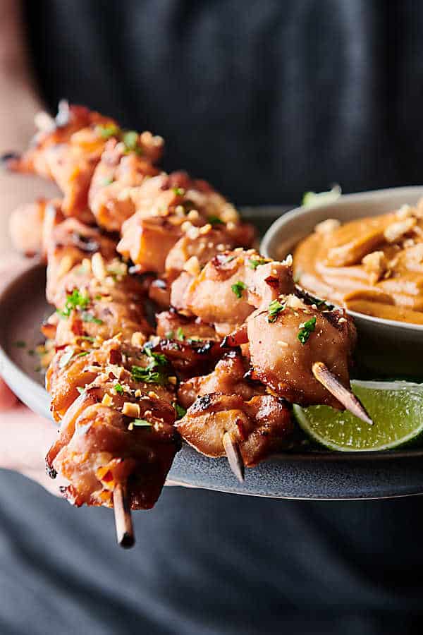 chicken satay skewers on plate with thai peanut sauce