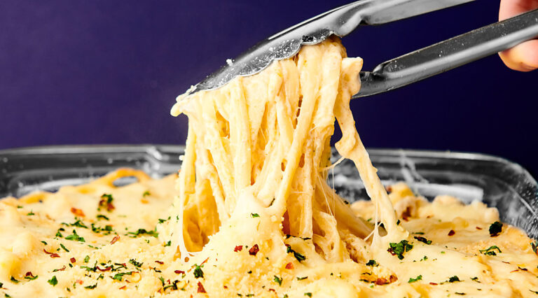chicken tetrazzini being served with tongs
