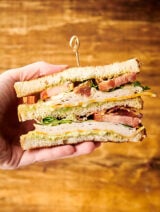 two halves of club sandwich held