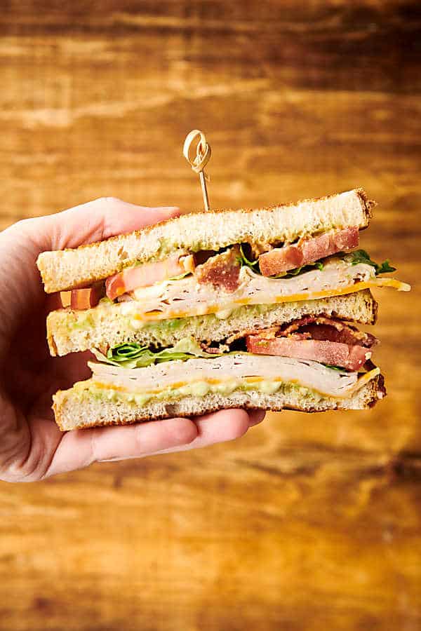 club sandwich half held