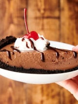slice of chocolate pudding pie on plate held