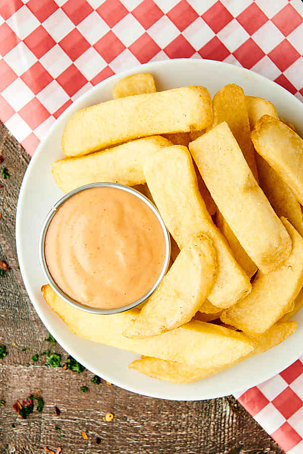 plate of fries with fry sauce above