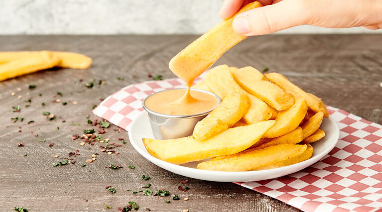 plate of fries with fry sauce, fry being dipped