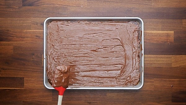 melted chocolate being spread over brittle