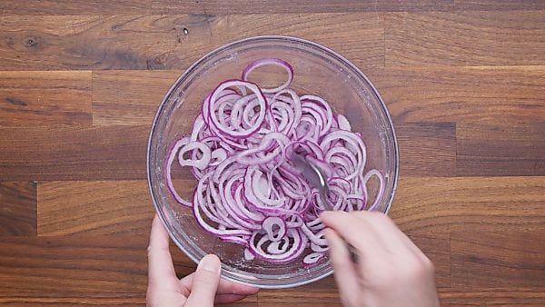red onions in bowl with salt