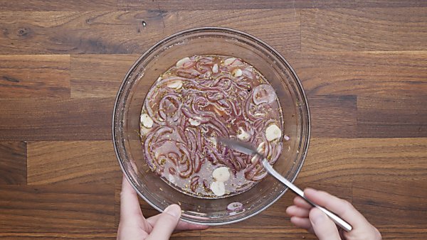 red onions with brine in mixing bowl
