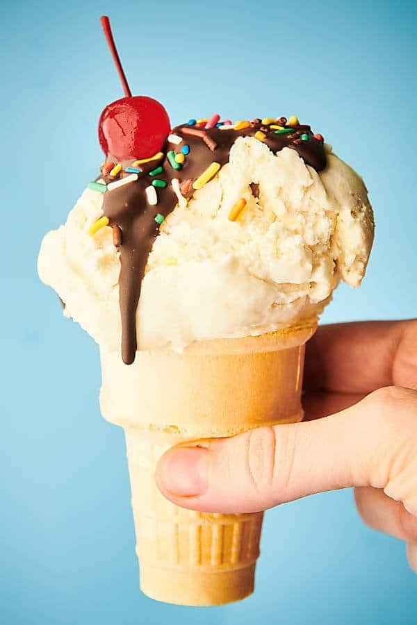 vanilla ice cream cone held